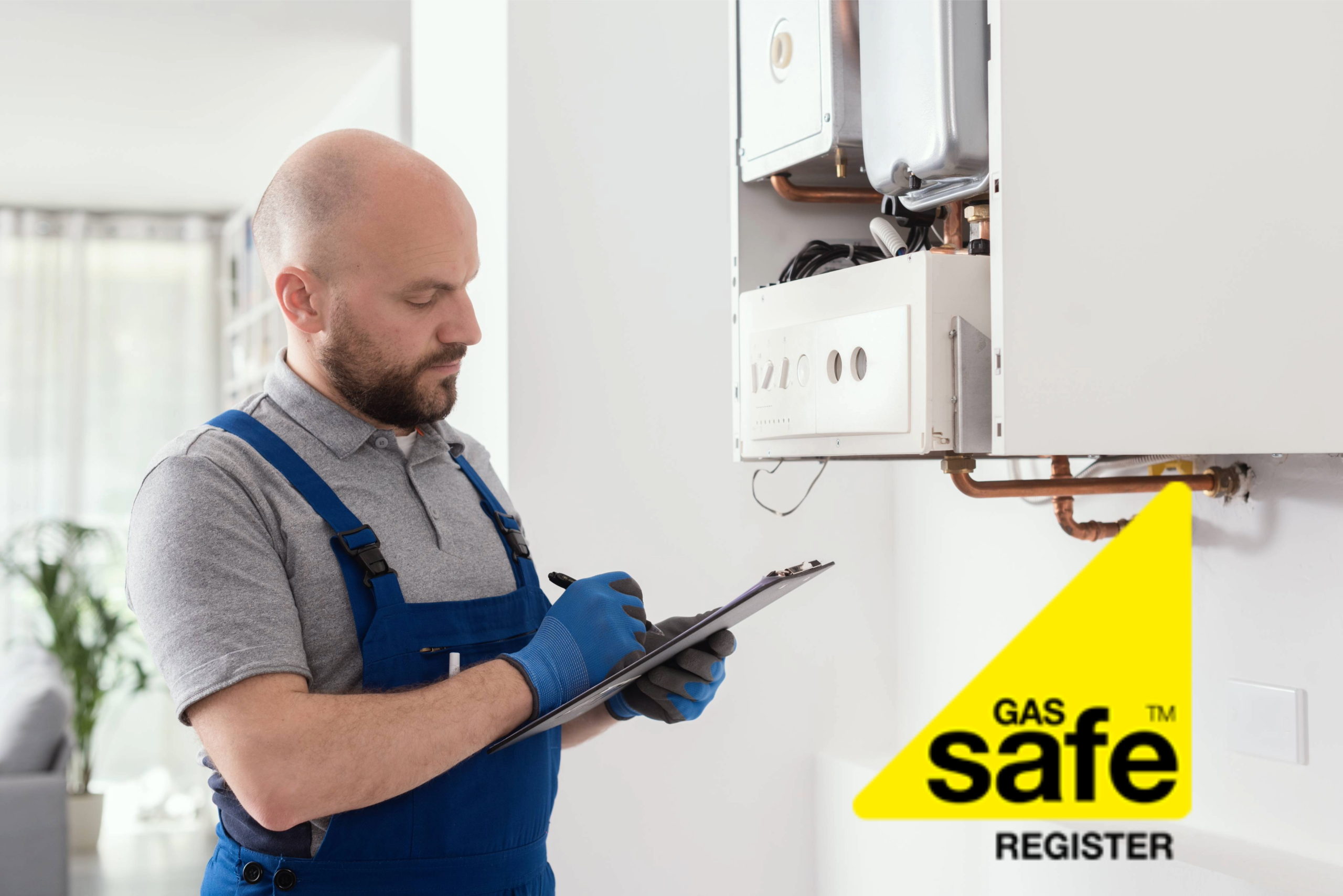 Gas engineer dressed in overalls inspecting a boiler